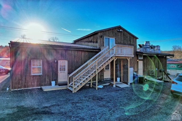 rear view of property featuring a deck