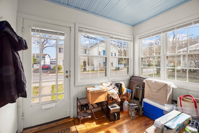 sunroom / solarium with plenty of natural light and wood finished floors
