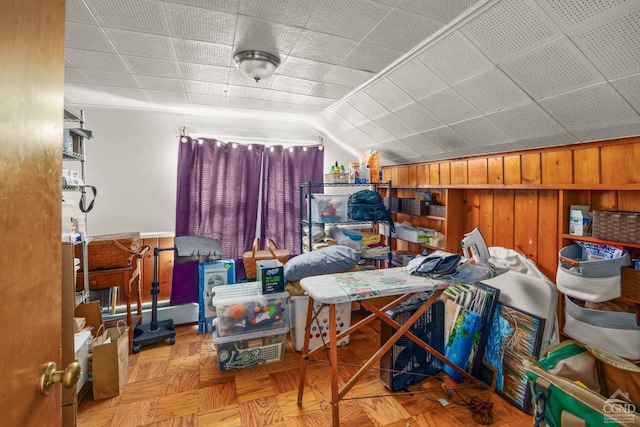 additional living space with wooden walls and vaulted ceiling