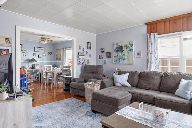living area with a ceiling fan and wood finished floors