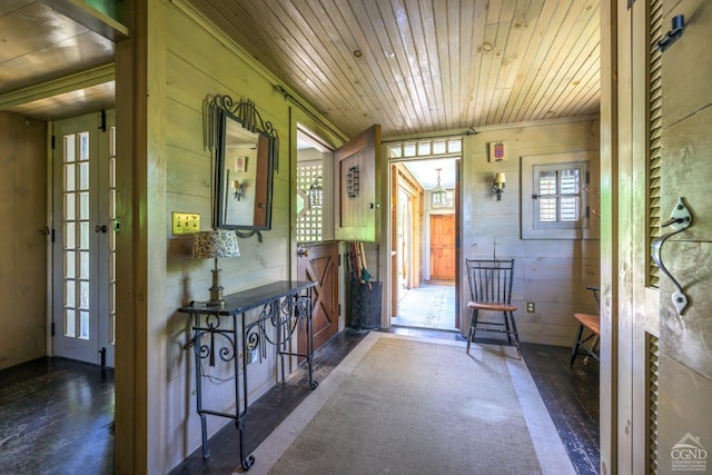 foyer with dark hardwood / wood-style floors, wood walls, and wood ceiling