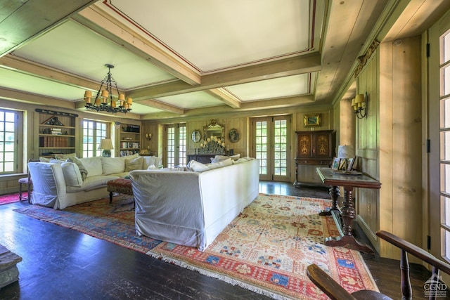 living room with wooden walls, french doors, and dark wood-type flooring