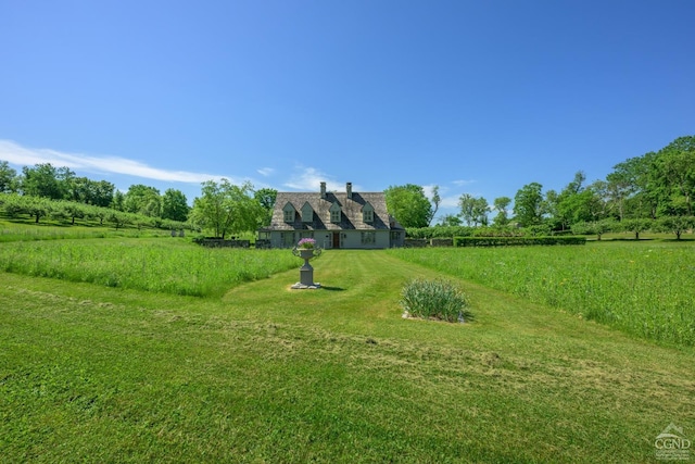 surrounding community with a rural view and a yard