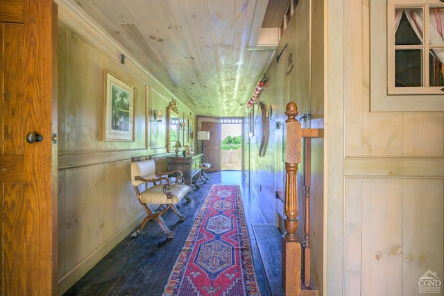 hallway featuring wood walls, hardwood / wood-style floors, and wood ceiling