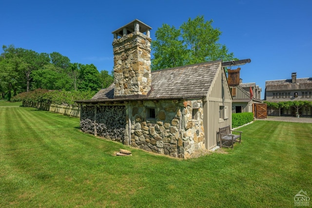 view of outbuilding with a lawn