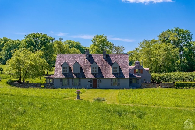 cape cod home with a front lawn