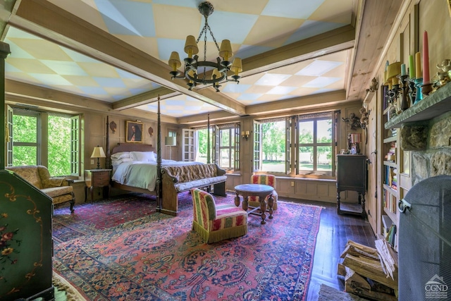 bedroom with dark wood-type flooring and an inviting chandelier