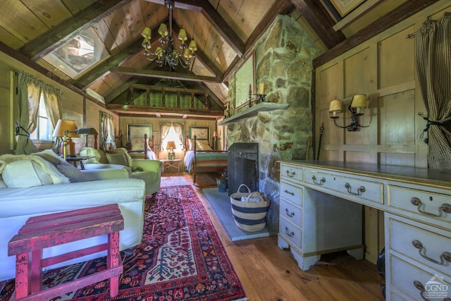 living area with a chandelier, vaulted ceiling with beams, hardwood / wood-style flooring, and wood ceiling