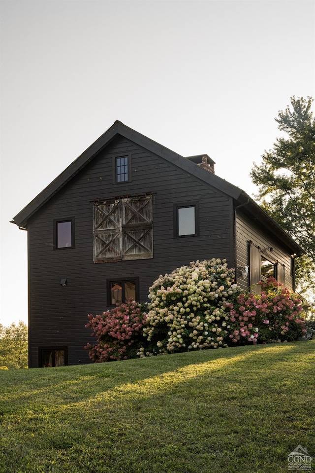 view of side of property with a lawn