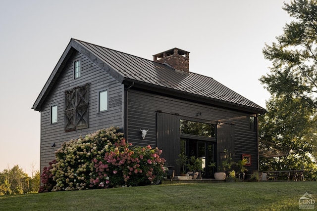 view of side of home with a yard