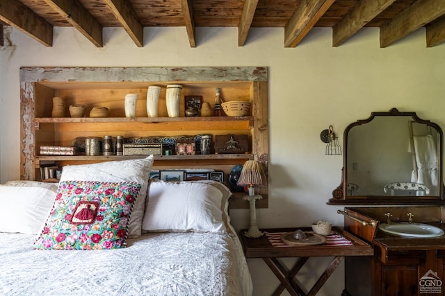 bedroom featuring beam ceiling, sink, and wood ceiling