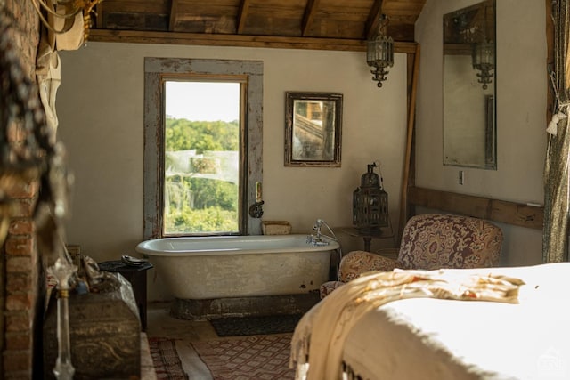 bathroom with a washtub, vaulted ceiling, and wooden ceiling