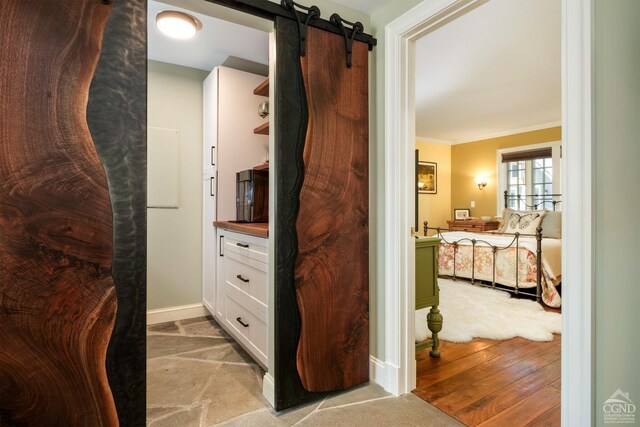 interior space with hardwood / wood-style floors, vanity, and crown molding