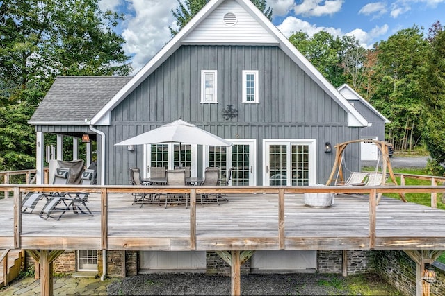 back of property featuring a wooden deck