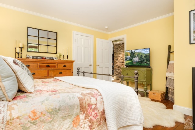 bedroom featuring wood-type flooring and crown molding