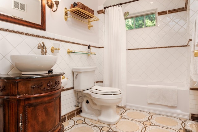 full bathroom with tile patterned floors, sink, shower / bathtub combination with curtain, and tile walls