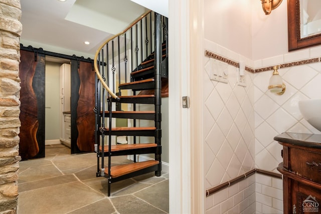 staircase featuring tile walls