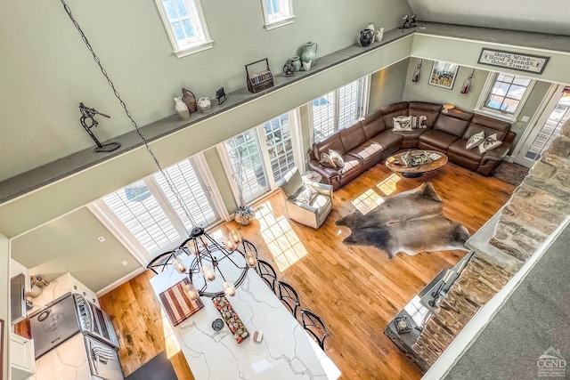 living room featuring a towering ceiling and a wealth of natural light