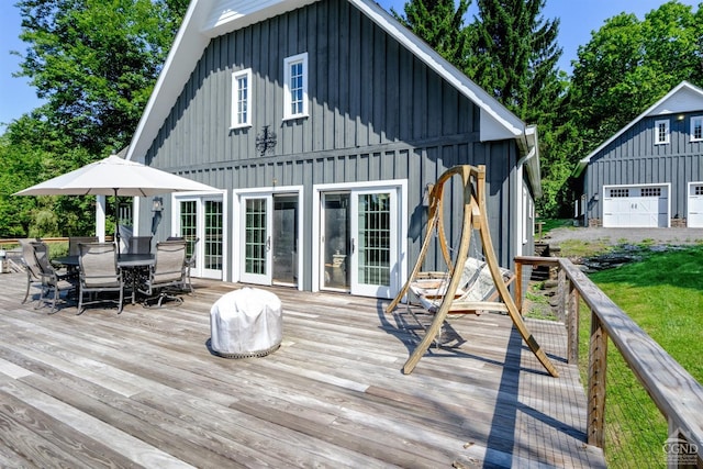 deck featuring an outbuilding and a garage