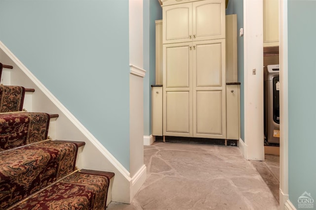 stairway featuring carpet and washer / clothes dryer