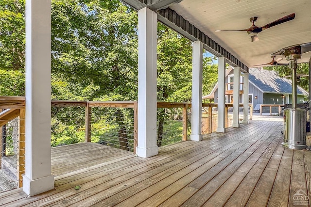 wooden terrace featuring ceiling fan and a porch