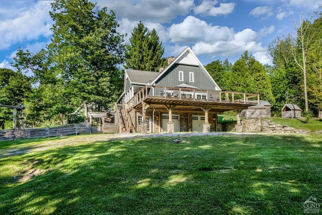 back of property featuring a lawn and a deck