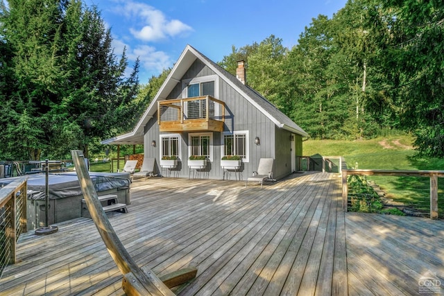 wooden terrace featuring a hot tub