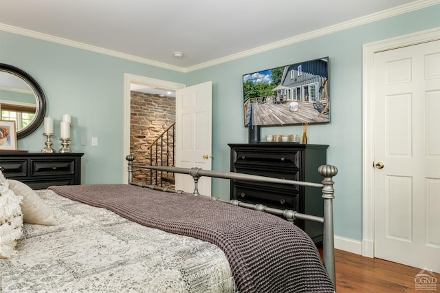 bedroom with crown molding and dark hardwood / wood-style floors