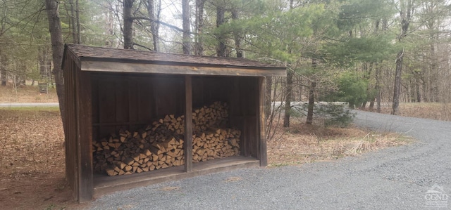 view of outdoor structure with an outbuilding and a forest view
