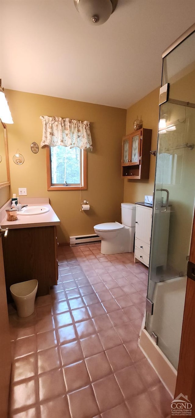 full bathroom with a baseboard radiator, vanity, a shower stall, and tile patterned flooring
