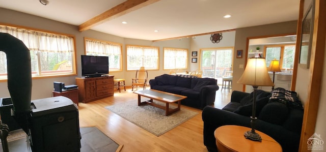 living room with beam ceiling, recessed lighting, and light wood finished floors
