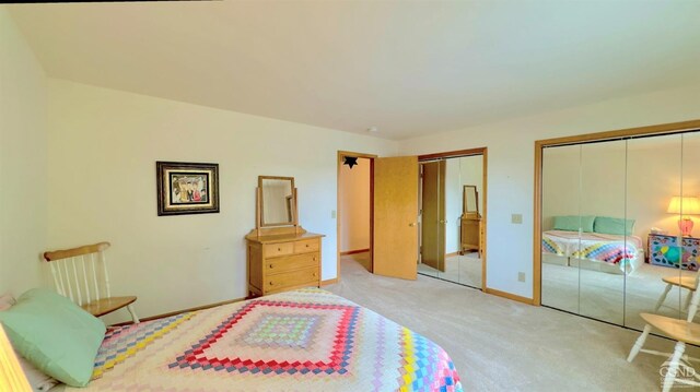 bedroom with two closets and light colored carpet