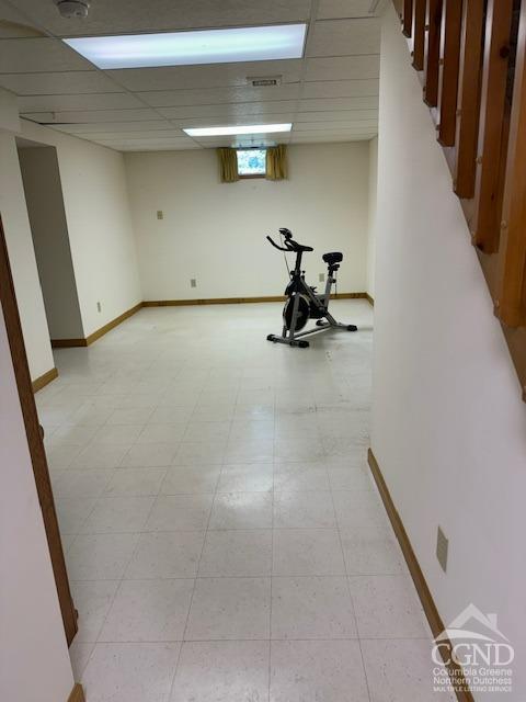 exercise area with a paneled ceiling