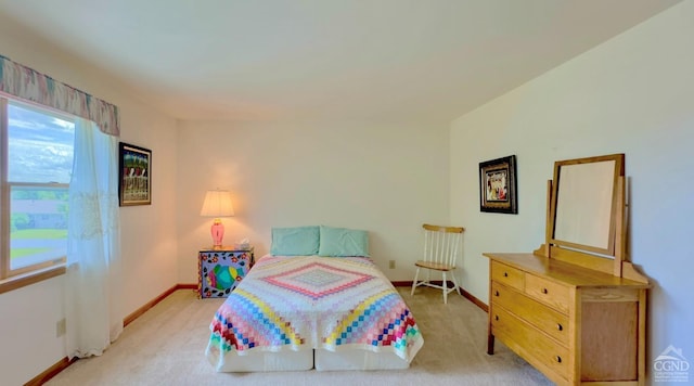 bedroom featuring light carpet