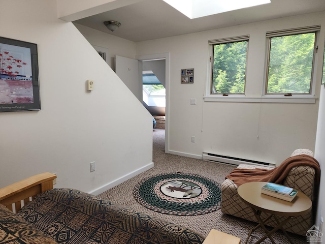 living area featuring a healthy amount of sunlight, a skylight, carpet floors, and a baseboard heating unit