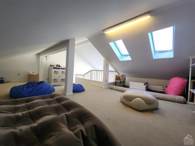 bedroom featuring lofted ceiling with skylight and carpet