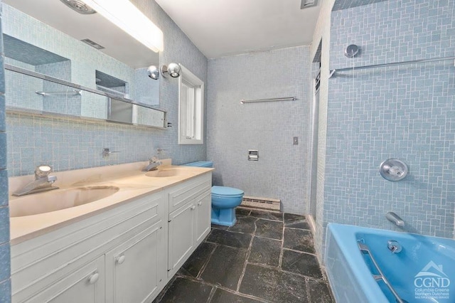 full bathroom with vanity, tiled shower / bath combo, toilet, baseboard heating, and tile walls