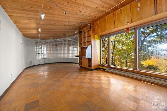 unfurnished room with lofted ceiling, baseboard heating, and wood ceiling