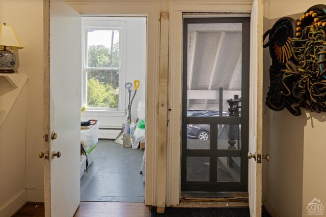 doorway with baseboard heating and dark wood-type flooring