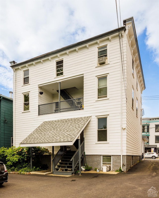 back of property with a balcony and cooling unit