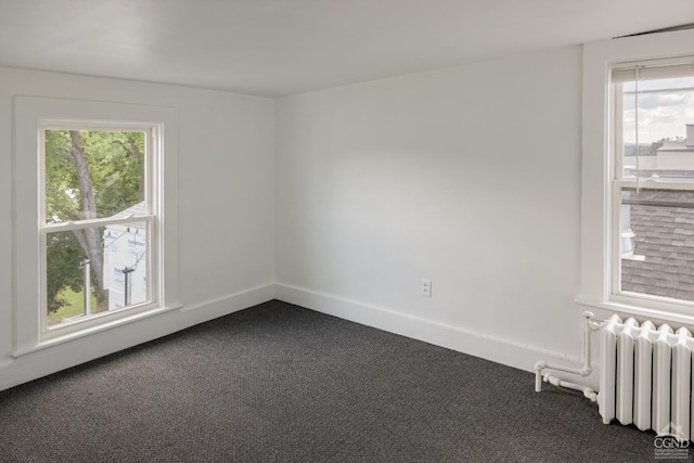 carpeted empty room with radiator