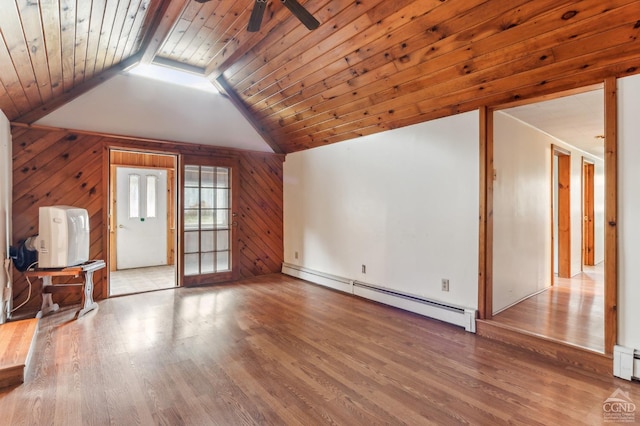 additional living space with wooden walls, a baseboard heating unit, lofted ceiling with beams, light hardwood / wood-style flooring, and wooden ceiling