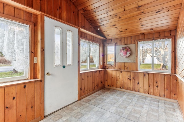 unfurnished sunroom with vaulted ceiling, plenty of natural light, and wooden ceiling