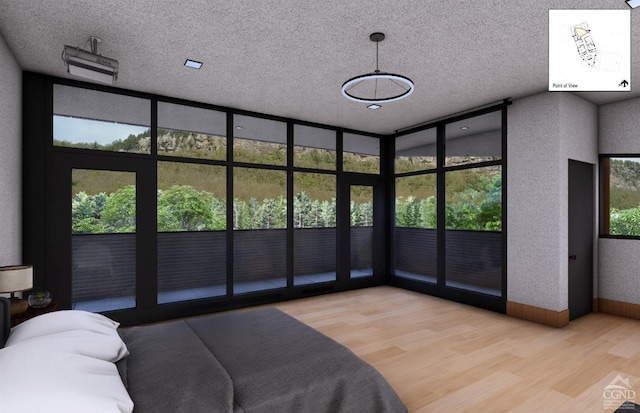 bedroom with a textured ceiling and light hardwood / wood-style flooring