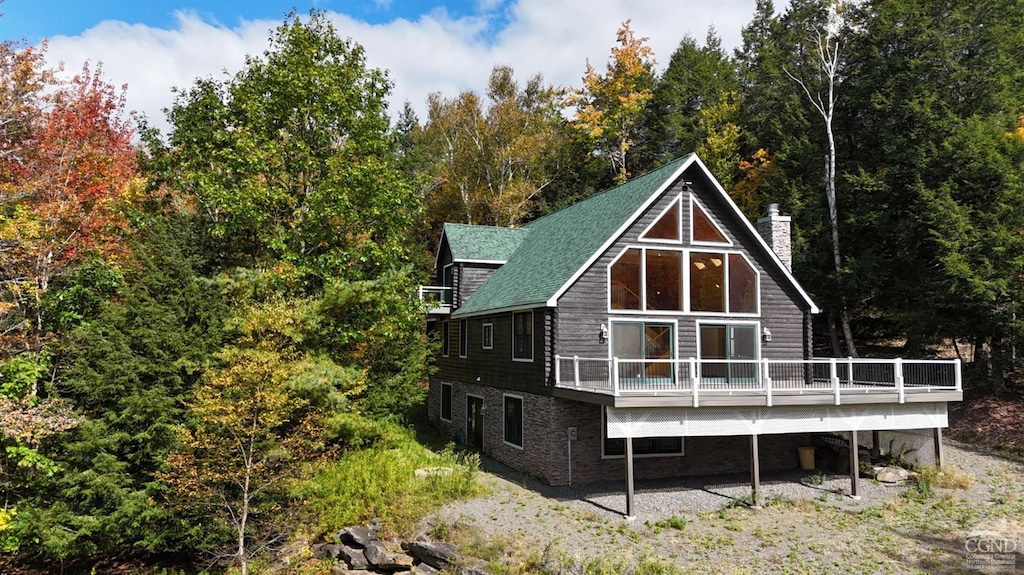 rear view of house with a wooden deck