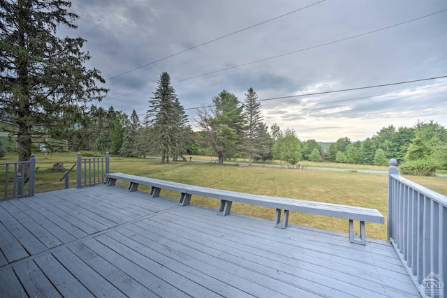 wooden terrace featuring a lawn