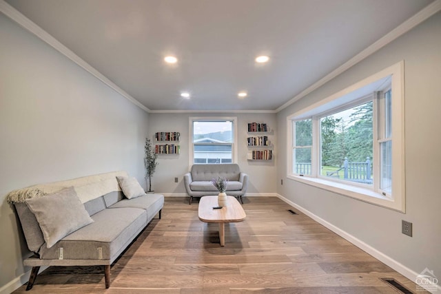 living room with crown molding and light wood-type flooring