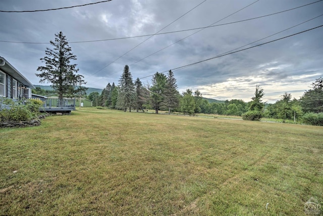 view of yard with a wooden deck