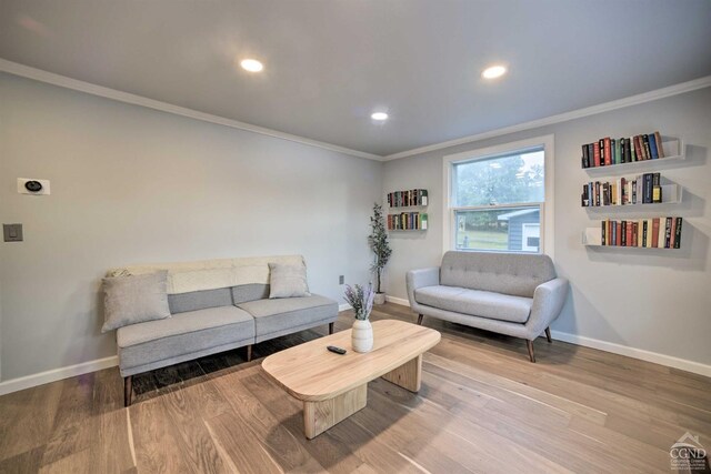 living room featuring hardwood / wood-style flooring and ornamental molding