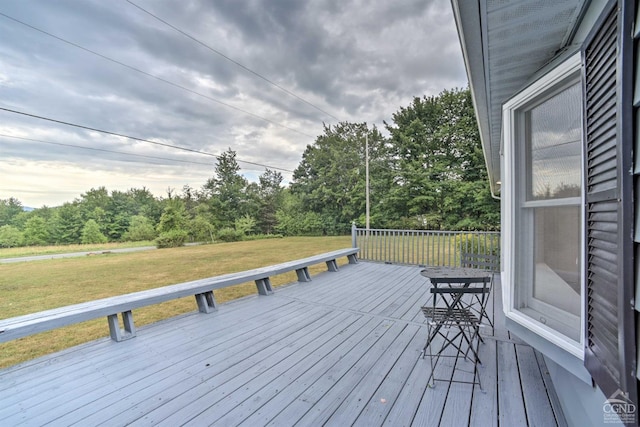 wooden terrace with a yard